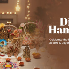 Diwali hampers with decorative baskets, diyas, sweets, and festive lights on a table.