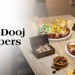 Bhai Dooj hampers with sweets, candles, jars, and festive decor on a table