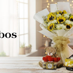 Gift combo with sunflower bouquet, teddy bear, Ferrero Rocher chocolates, and yellow cake