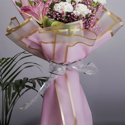 Elegant pink flower bouquet with white and pink blooms in decorative wrap
