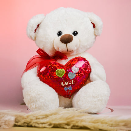 White teddy bear with red heart pillow and love balloons, pink background, gift idea
