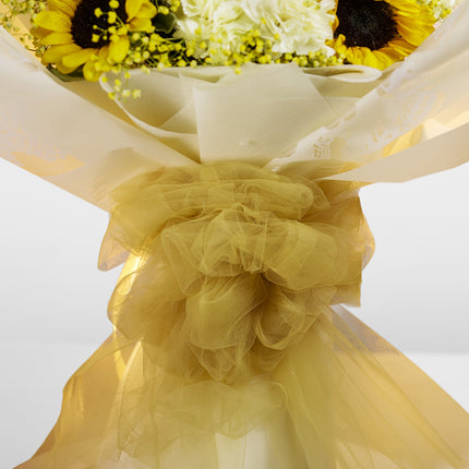 Sunflower bouquet with yellow tulle bow and white wrapping, floral arrangement gift