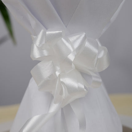 Close-up of white satin ribbon bow on white gift wrap, elegant packaging detail