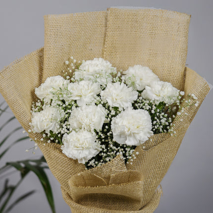 White carnation bouquet with baby's breath in burlap wrap, floral arrangement